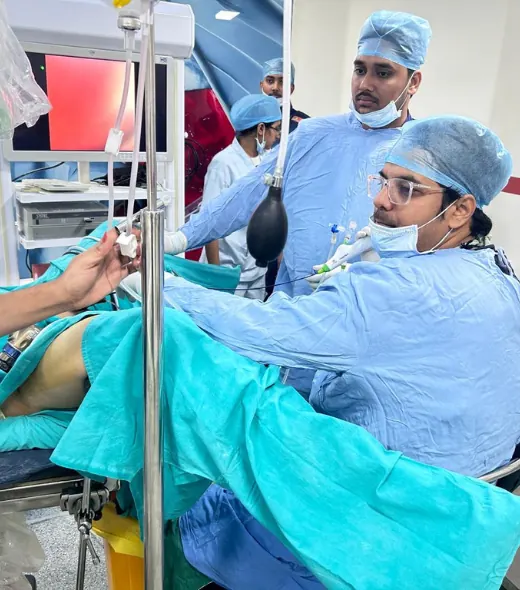 Dr. Aditya P.S. Sengar performing an endoscopic urology procedure in a hospital operation theatre